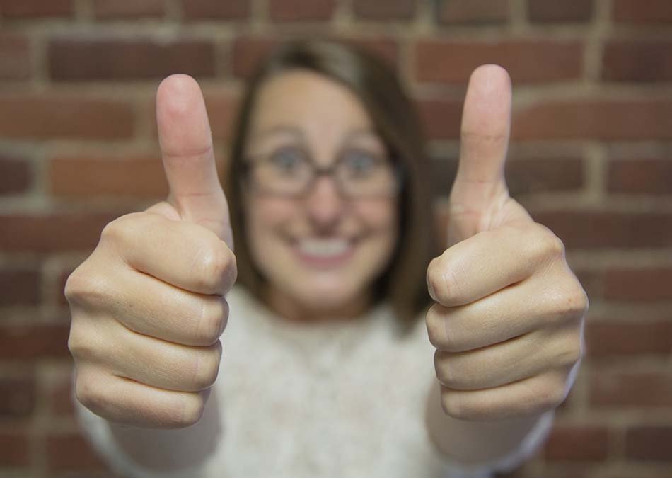 Woman with both thumbs up
